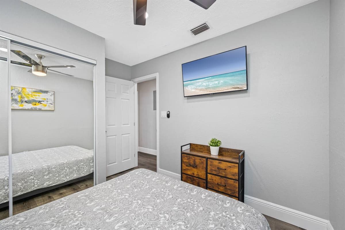 Comfortable bedroom with queen sized bed, smart TV and full sized mirror closet. Sleep safe and sound on the comfort of your home away from home. If you have any questions, send us a message!