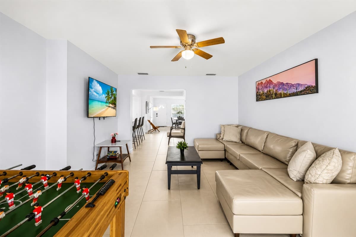 Open living room with foosball table, entertainment space, and cozy sectional seating.