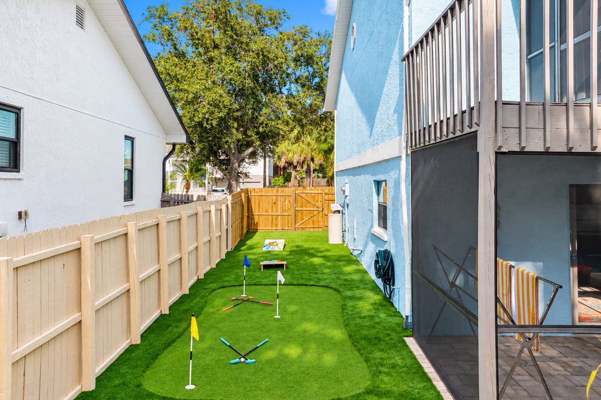 With a colorful cornhole set and putting green just steps from the patio, this fenced-in yard offers endless entertainment without leaving home.