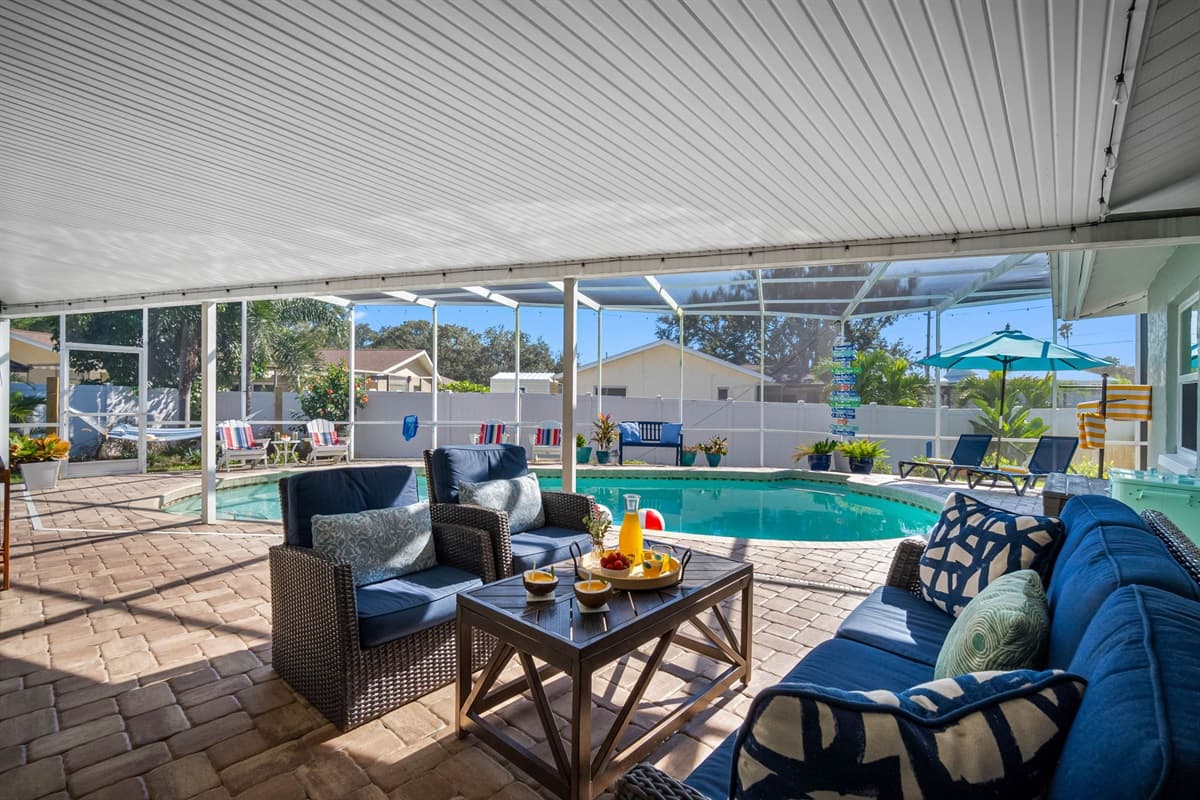 Spacious, inviting, and beautifully lit, this screened pool area is perfect for family fun, afternoon swims, or dining al fresco by the water.