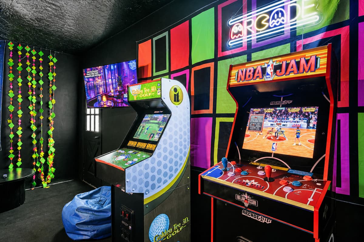 Two arcade cabinets on free play, beanbag on the floor, no quarters needed. They'll be in here for hours.