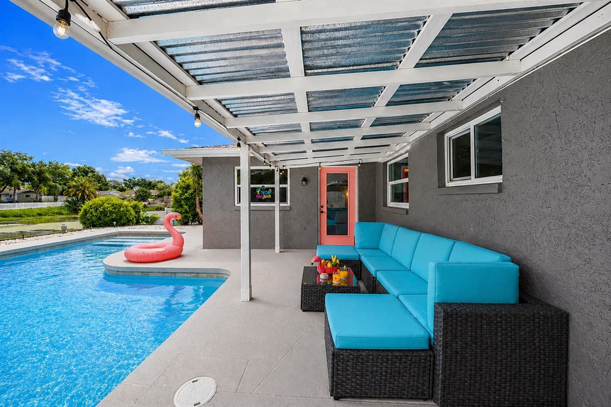 Full patio view with covered seating and direct access to the private pool.