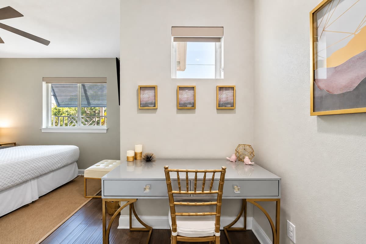 For those who need to stay connected or catch up on work, a sleek writing desk is provided, complete with charging ports and a comfortable chair.
