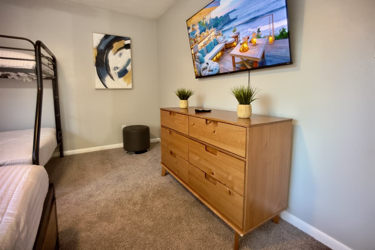 A well-appointed space featuring a queen-size bed and a bunk bed, perfect for a good night's sleep after a day of fun.