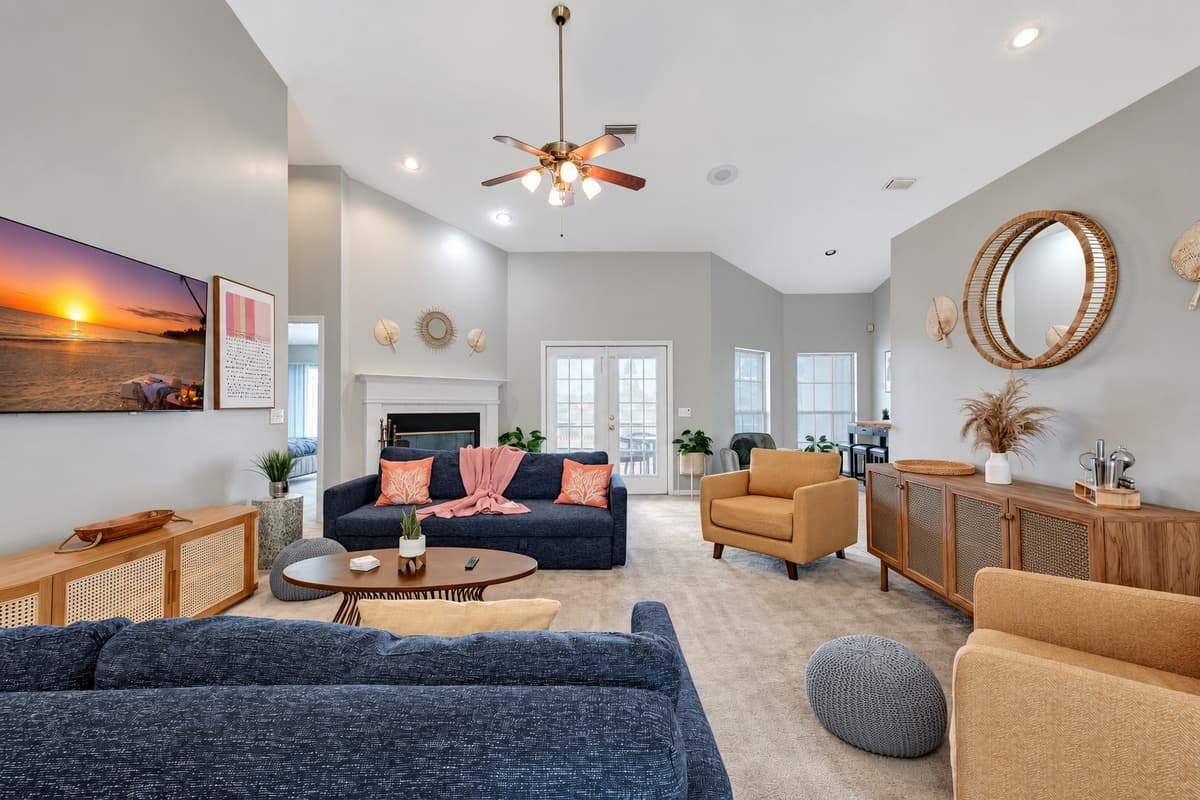 Adding a touch of natural warmth, you'll discover wooden accent console tables and cabinets scattered strategically throughout the room.