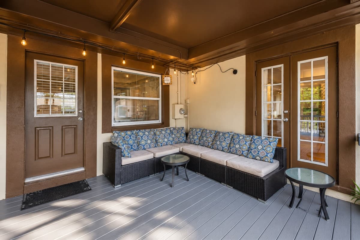 Comfortable outdoor lounge area featuring cushioned seating and ambient string lighting.