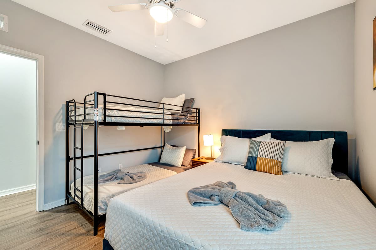 At the heart of the room stands a lavish queen-size bed, a sanctuary of tranquility adorned with soft linens and an abundance of plump pillows, promising a restful night's sleep.