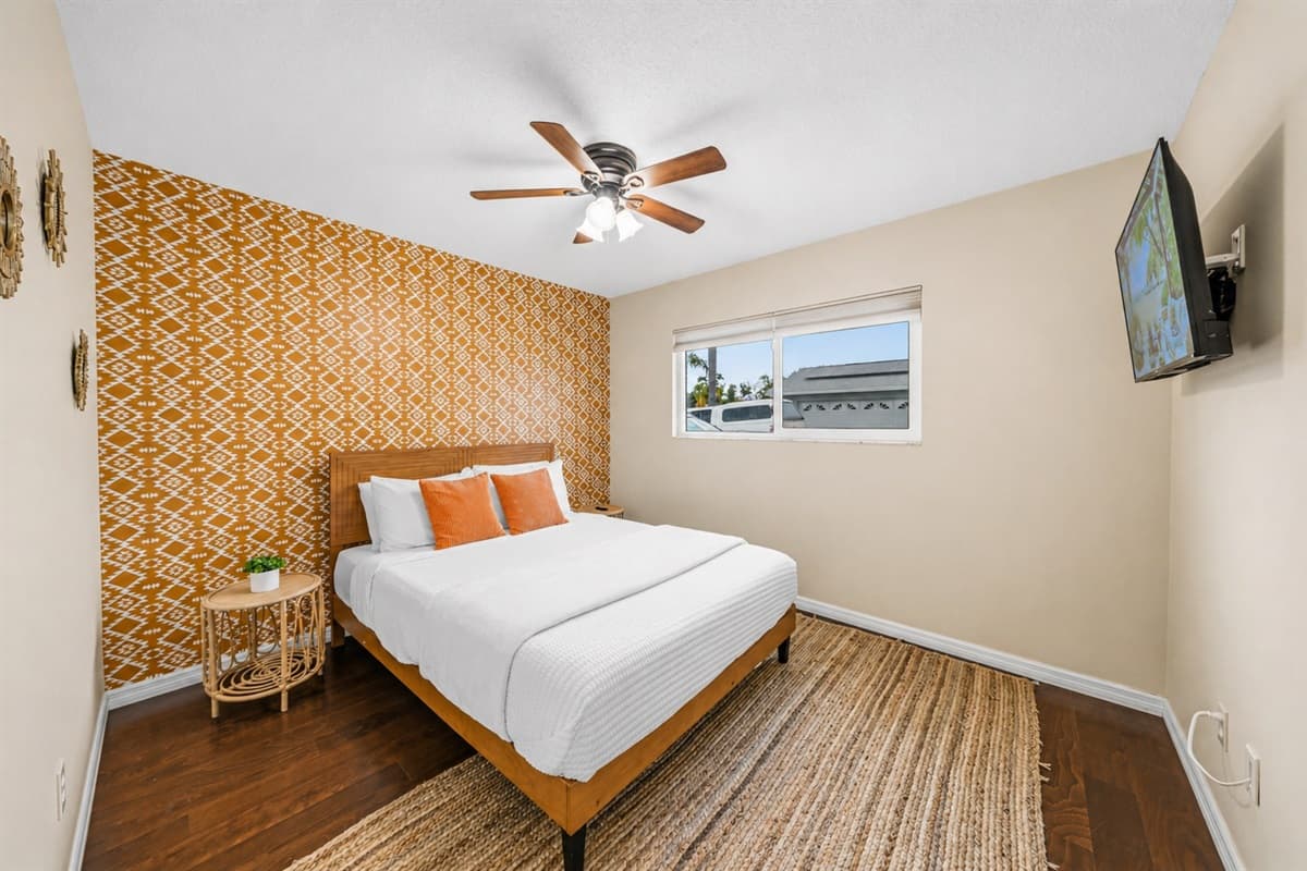 Cozy Bedroom 2 featuring a comfortable king bed, warm tones, and a stylish accent wall.