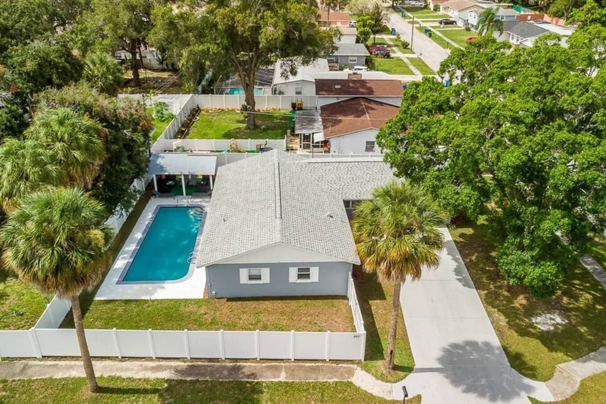 Aerial back view of this amazing property! Worry not about kids playing in the fully fenced backyard during your stay! Inquire about this property now!
