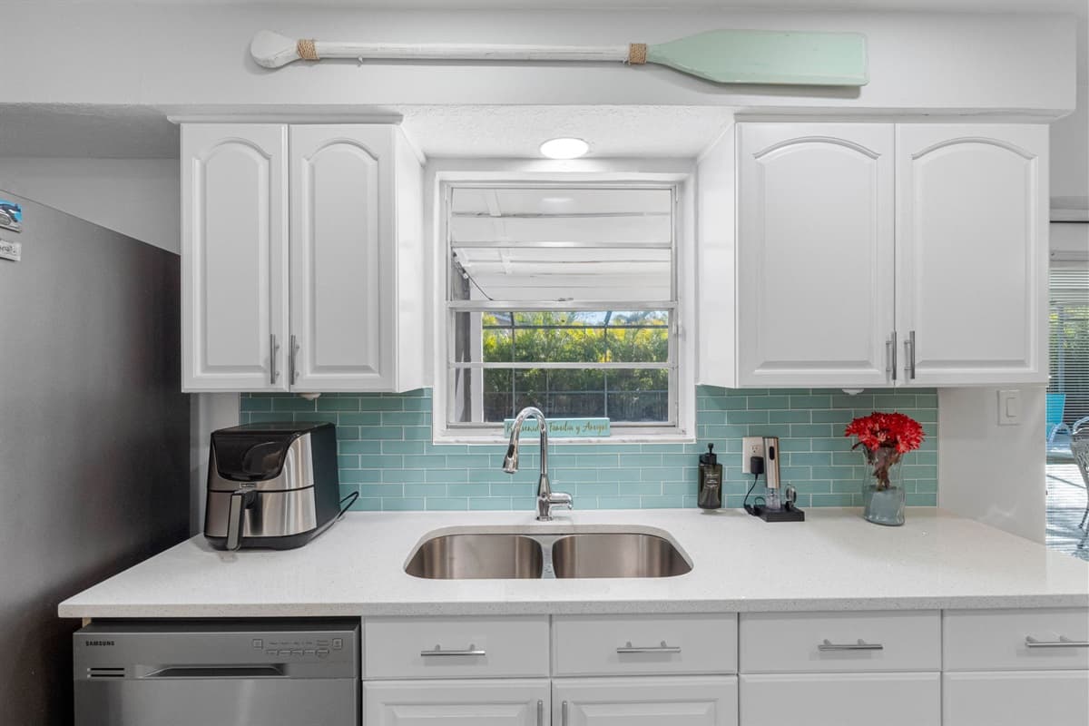 This fully equipped kitchen boasts state-of-the-art appliances, including a stainless steel refrigerator with ample storage space to keep your groceries fresh throughout your stay.