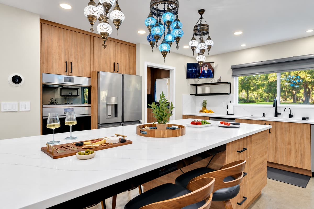 Bring a chef, or be one. Wide island, generous storage and pendant lighting over the whole thing, built for catering a party or making breakfast for twenty on a slow morning.