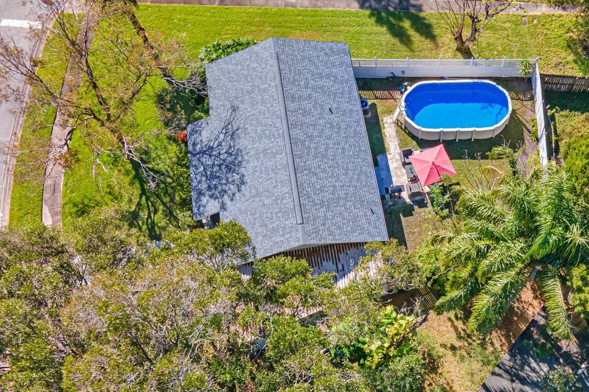 Aerial side view of our amazing property! Worry not about kids playing in the fully fenced backyard during your stay! Inquire about this property now!