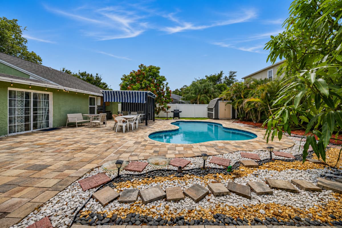 Large fenced backyard with lush landscaping, private pool, and plenty of room to relax.