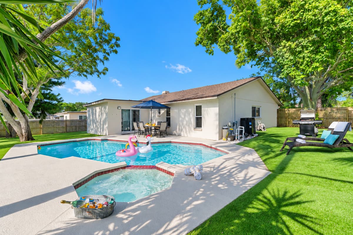 Surrounded by lush greenery, the pool area is designed to provide both relaxation and entertainment, creating an inviting atmosphere for all ages.