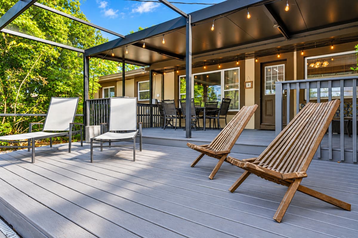 Cozy covered patio and poolside lounge area with ambient lighting and comfortable seating.