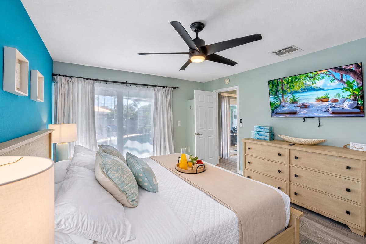 Unwind in this serene king suite with a soothing blue accent wall, large mirror, and spa-like ensuite bathroom.