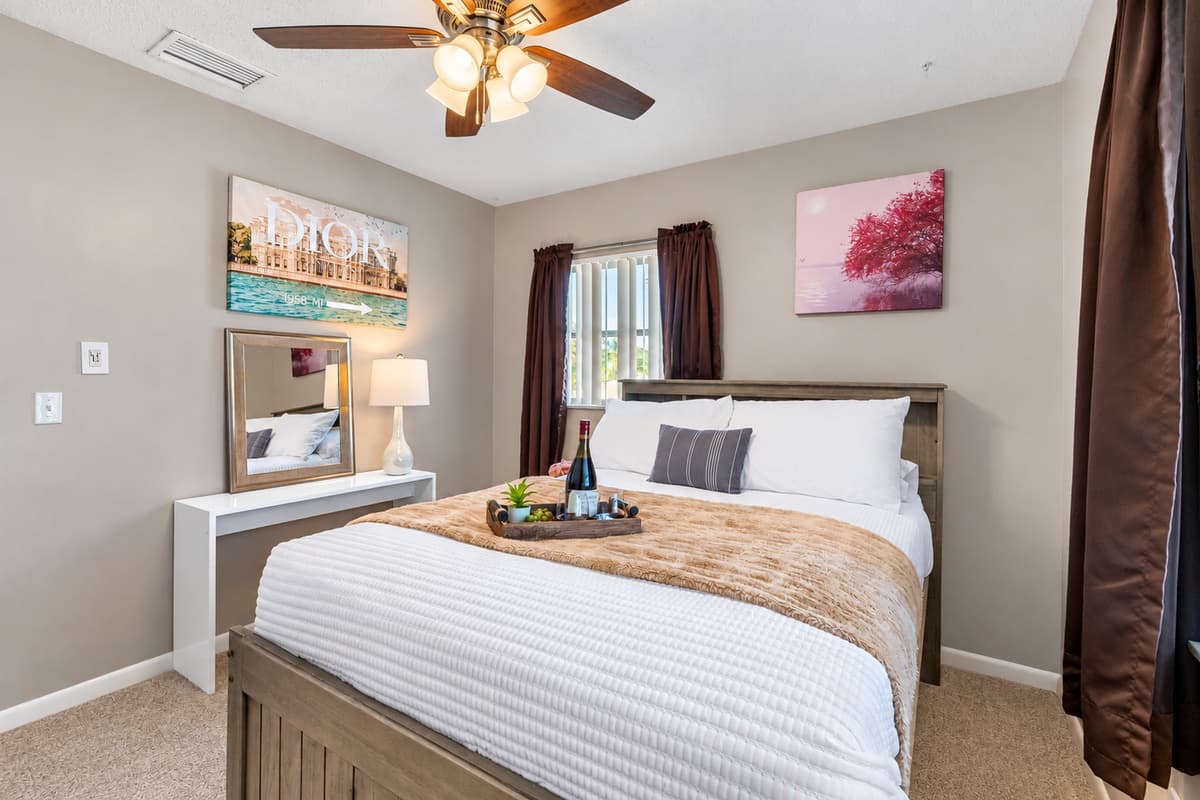 Neutral walls, crisp white bedding, and subtle accents provide timeless style and comfort.