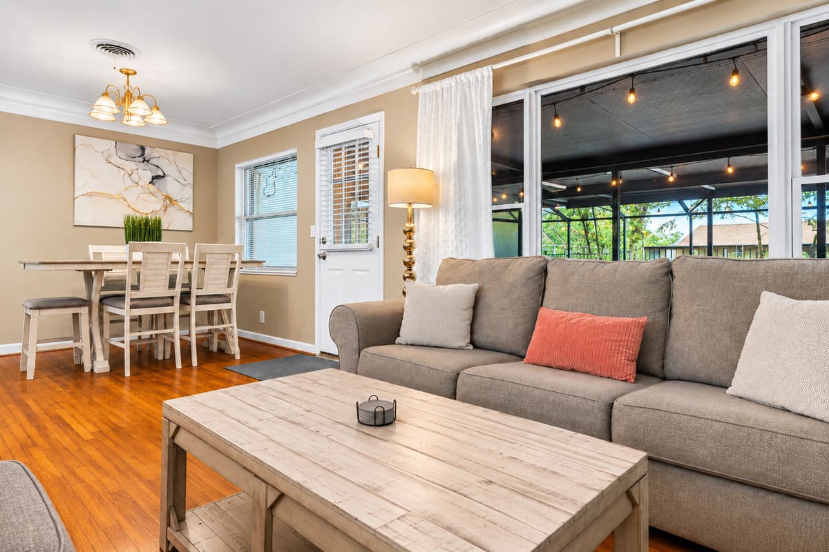 Bright and welcoming living room with cozy seating and an open connection to the dining area.