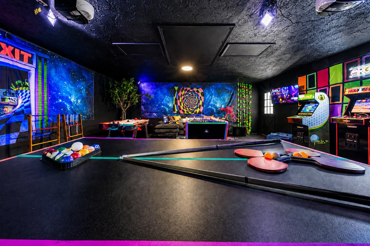 Air hockey, arcade cabinets, neon on every wall. The kids will find this room before they find their beds.