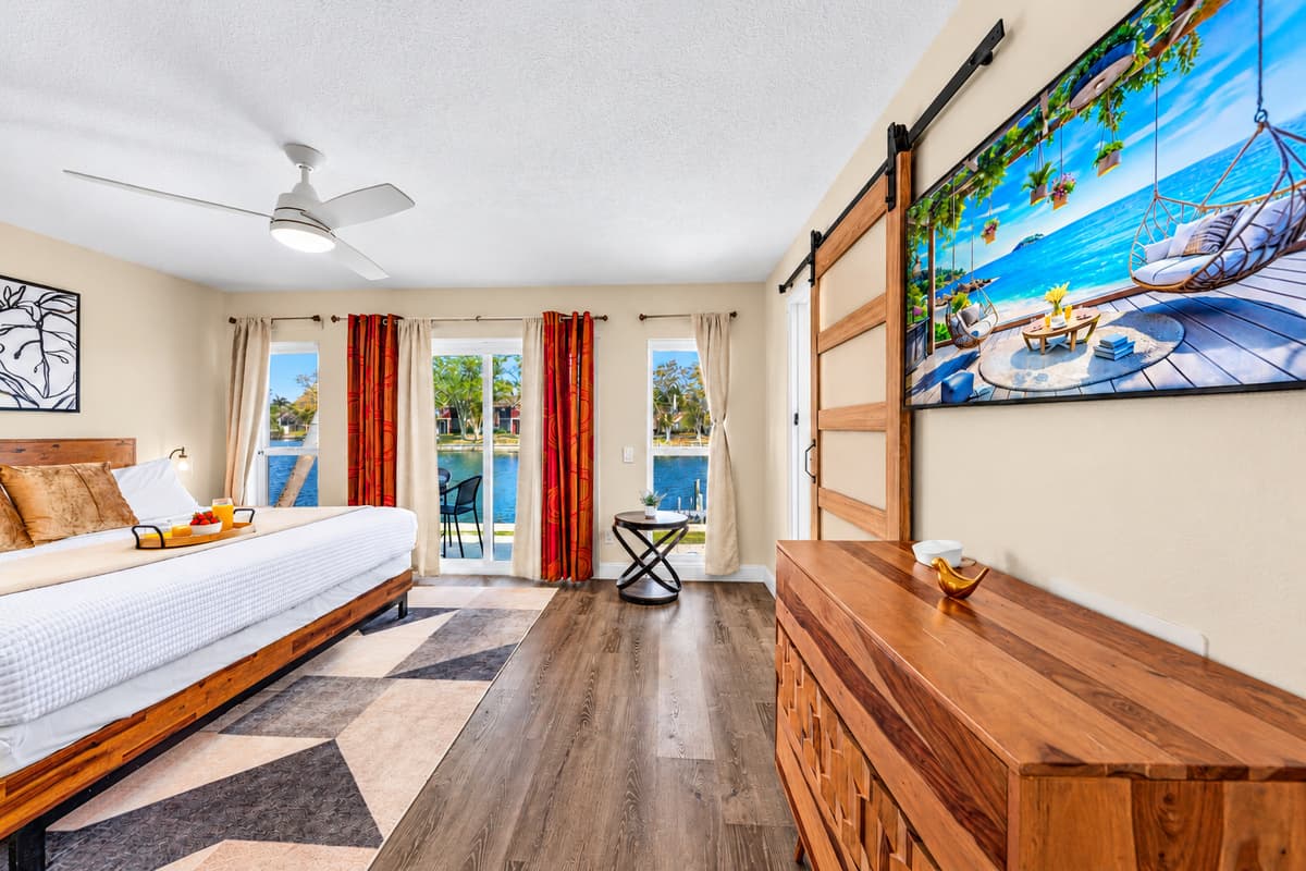 Large primary suite with Smart TV, queen bed, and direct access to the patio.