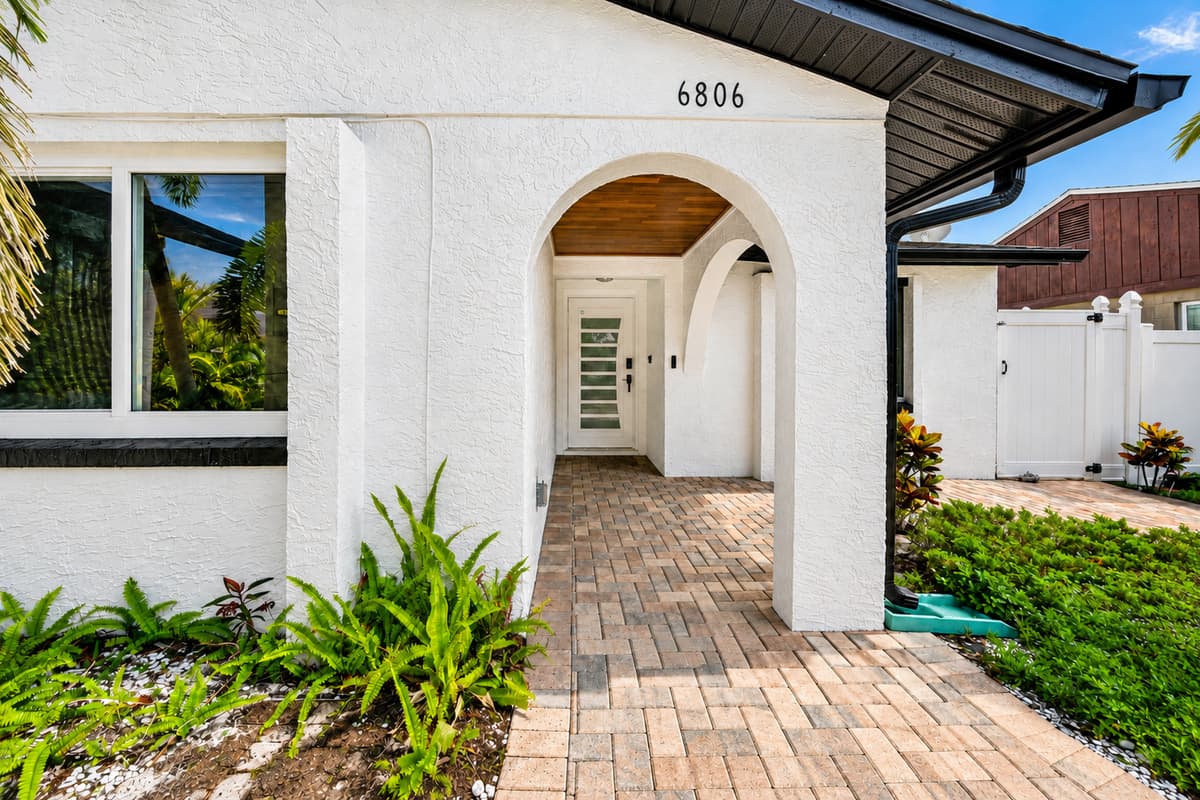 Beautiful front entrance with a covered walkway and stylish curb appeal, creating a warm first impression upon arrival.