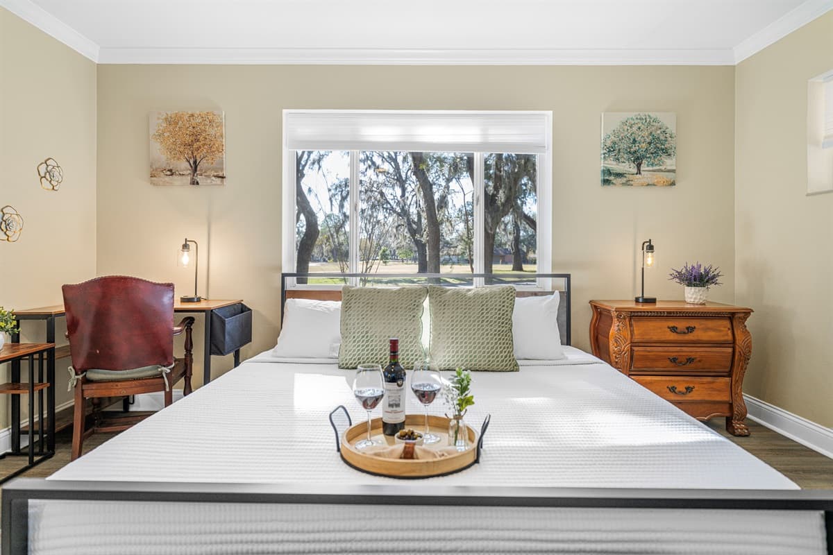 The king-size bed anchors this inviting bedroom, offering plush comfort and a tranquil retreat after a full day.