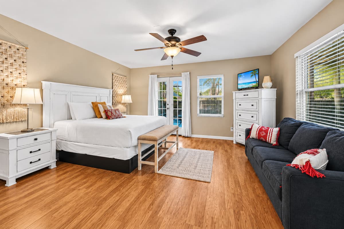 Inviting primary suite with spacious layout, comfortable seating, and relaxing coastal-inspired décor.