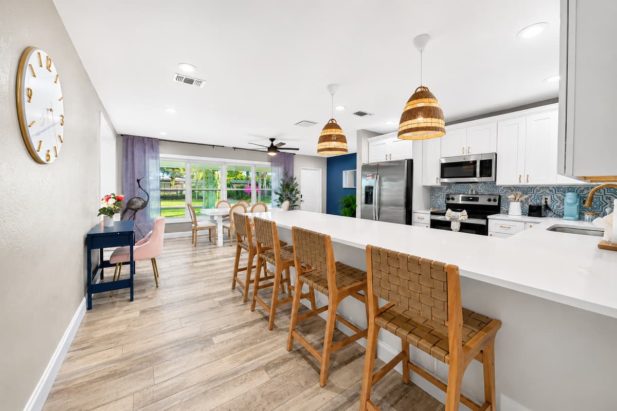 Oversized kitchen island with abundant workspace, custom cabinetry, and modern coastal finishes.