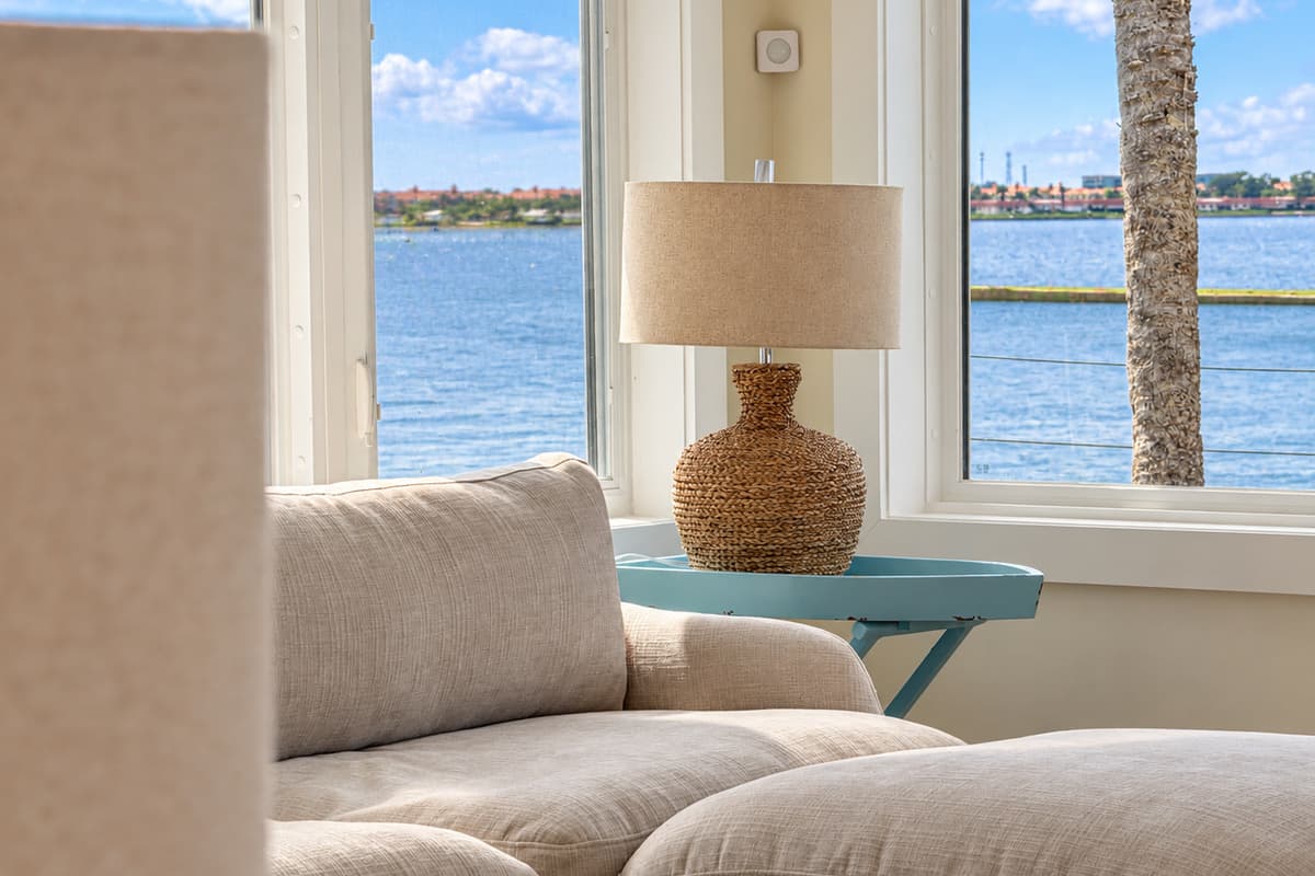 Waterfront living room with comfortable seating and wide water views.