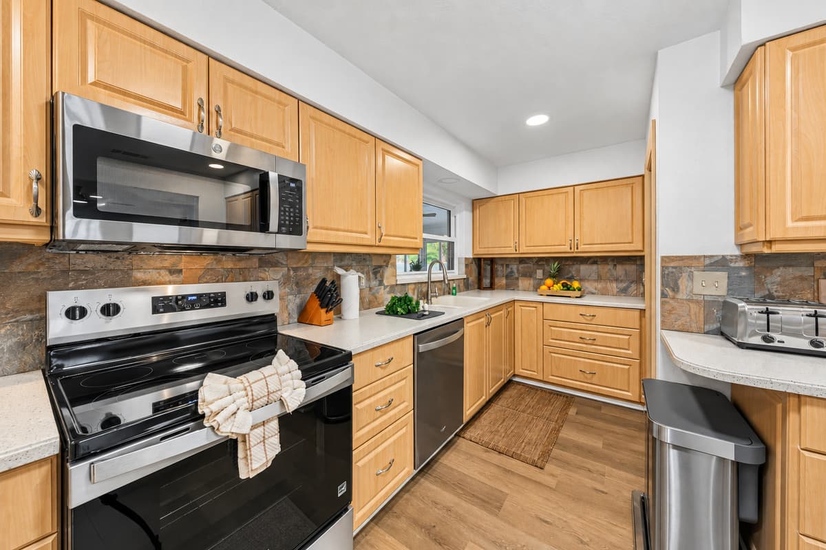 Modern kitchen with stainless steel appliances and functional layout for easy cooking and dining 