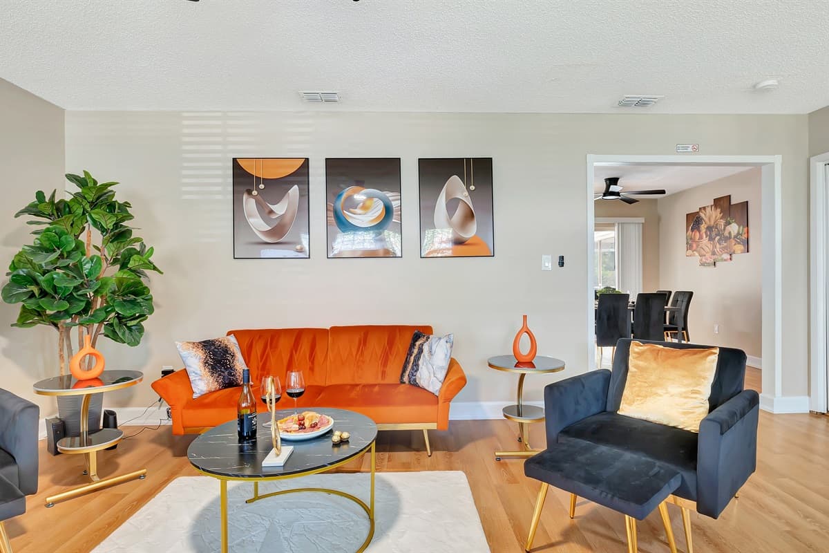 Feel the allure of our sumptuous, oversized sofas and armchairs, elegantly adorned in a captivating blend of vivid orange and deep navy blue, injecting a burst of vitality into the room.