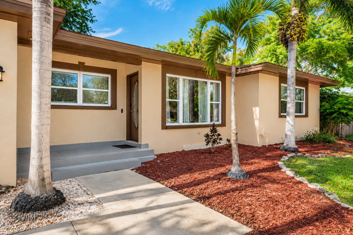 Beautiful exterior view showcasing the home’s modern design and lush palm trees.