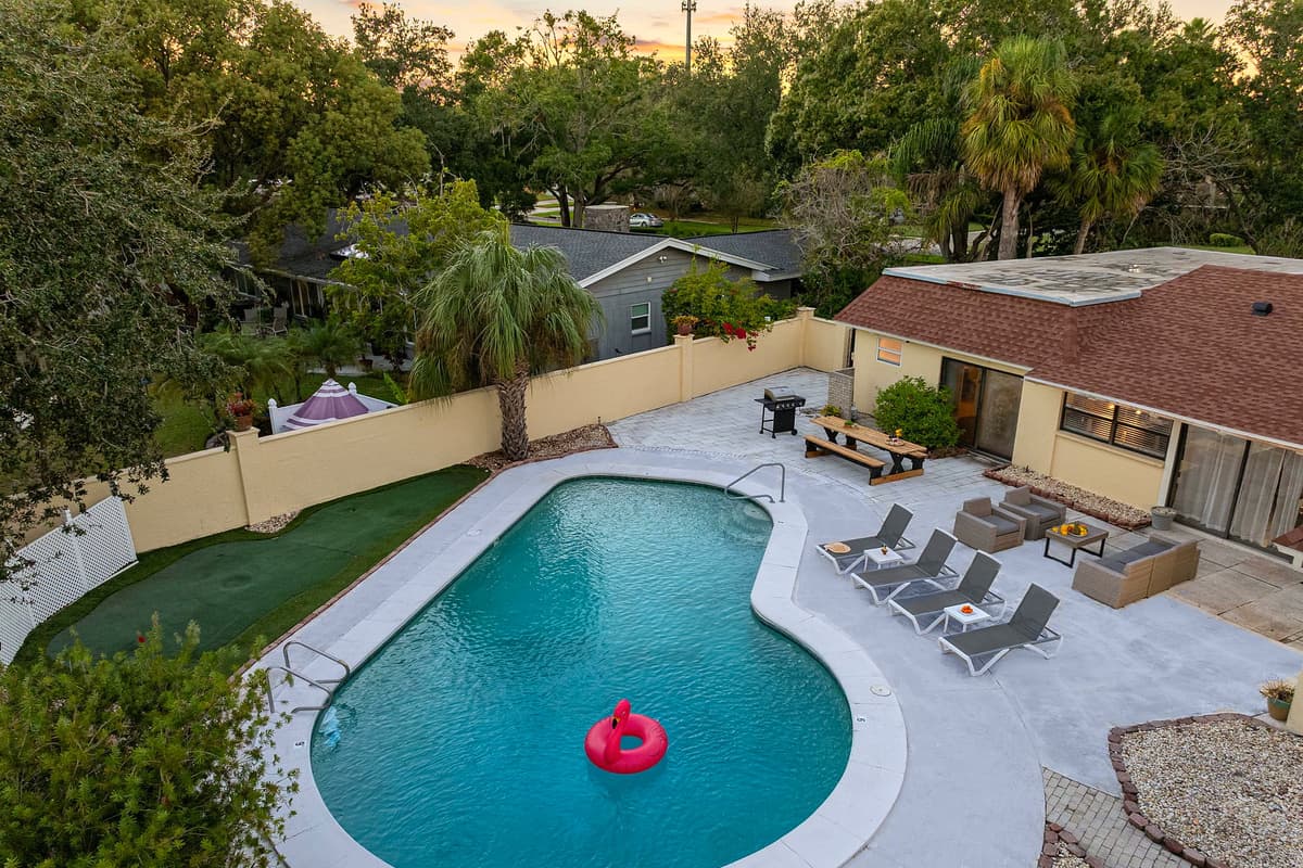 Surrounded by greenery and enclosed for privacy, this pool area offers a peaceful escape with plenty of space to lounge, dine, and unwind.