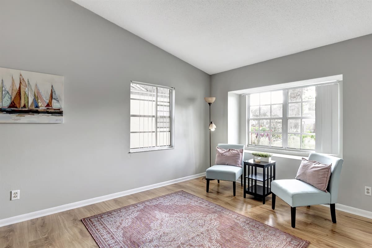An inviting extra seating nook bathed in natural light by the window.
