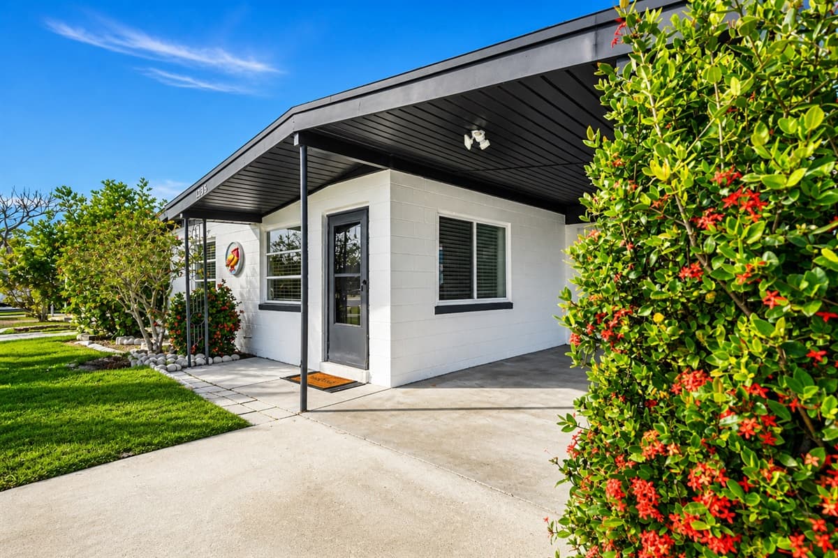 Exterior front corner view showcasing the home’s clean modern style and manicured landscaping.
