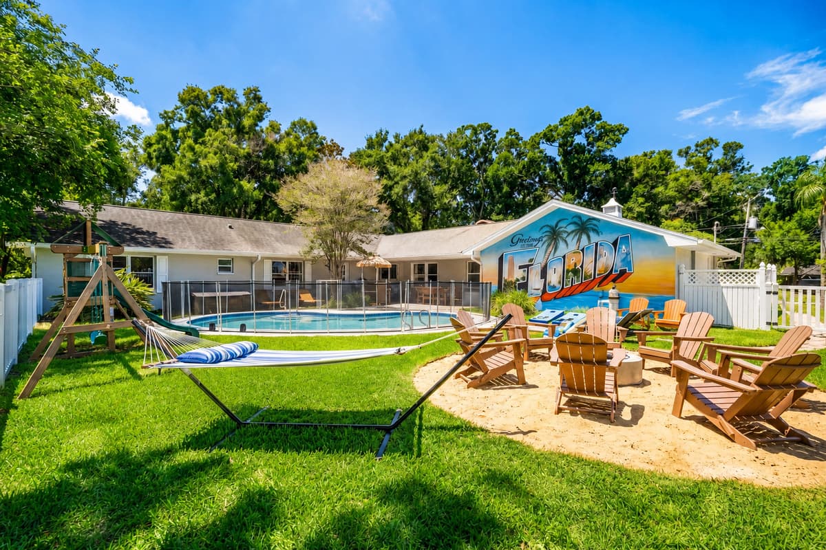Swing set, fire pit, hammock, and pool in a single fenced yard. Every age gets something.