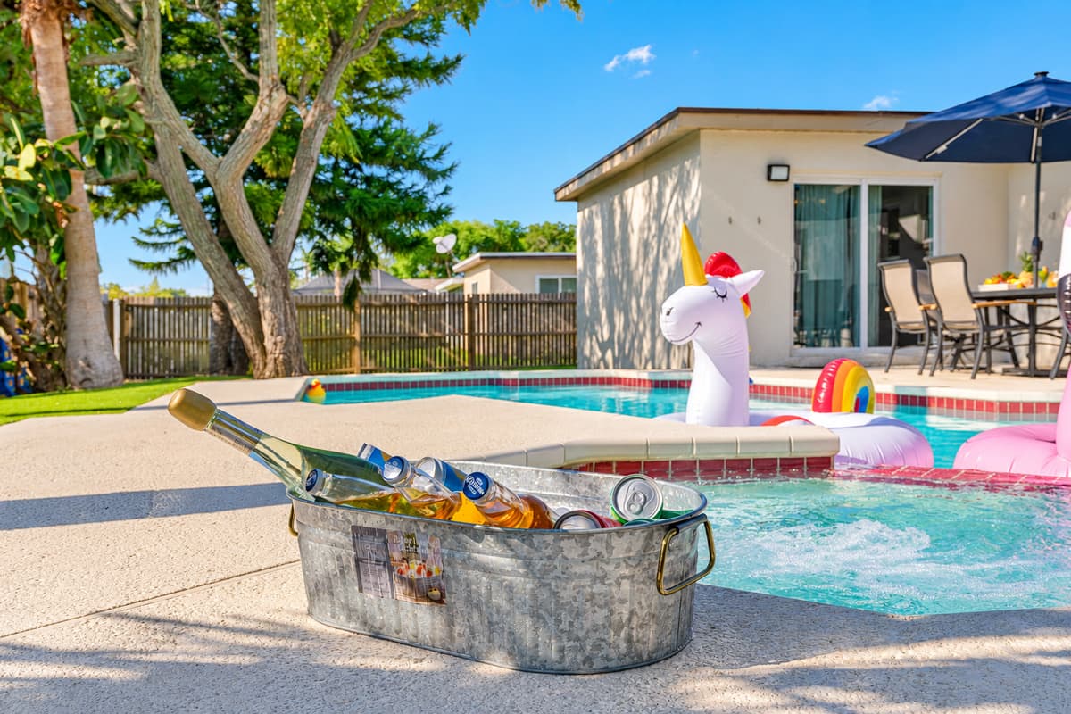 The pool itself is a sparkling oasis of cool, crystal-clear water, perfect for a refreshing dip on a warm day.