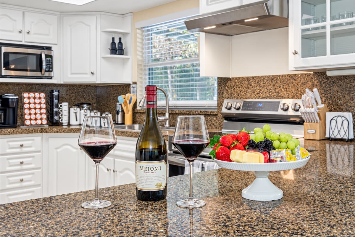 This kitchen is a masterpiece of design, with bright white painted cabinets that instantly elevate the space.
