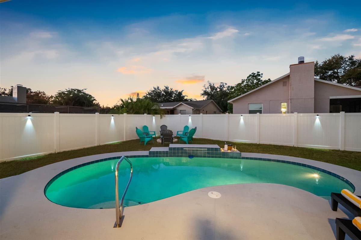 Experience the magic of resort living at home. The softly lit pool, elegant patio seating, and open-air dining area create the perfect setting for unforgettable nights.