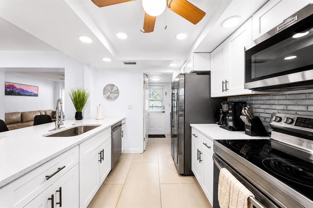 Sleek modern kitchen featuring stainless steel appliances, spacious countertops, and bright open layout.