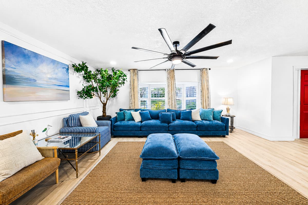 Bright room, soft rug, big windows — this is where everyone ends up between the pool and dinner.