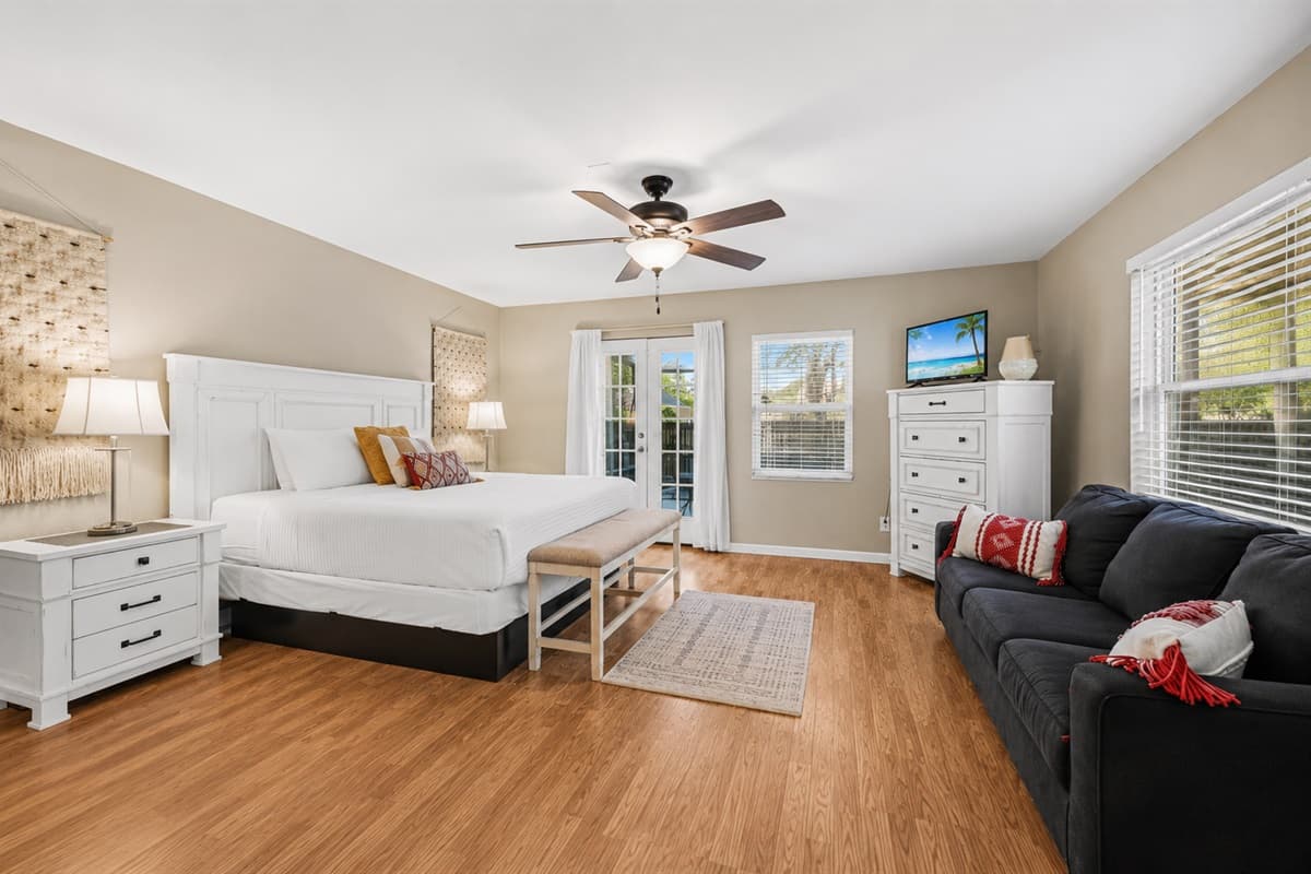 Inviting primary suite with spacious layout, comfortable seating, and relaxing coastal-inspired décor.