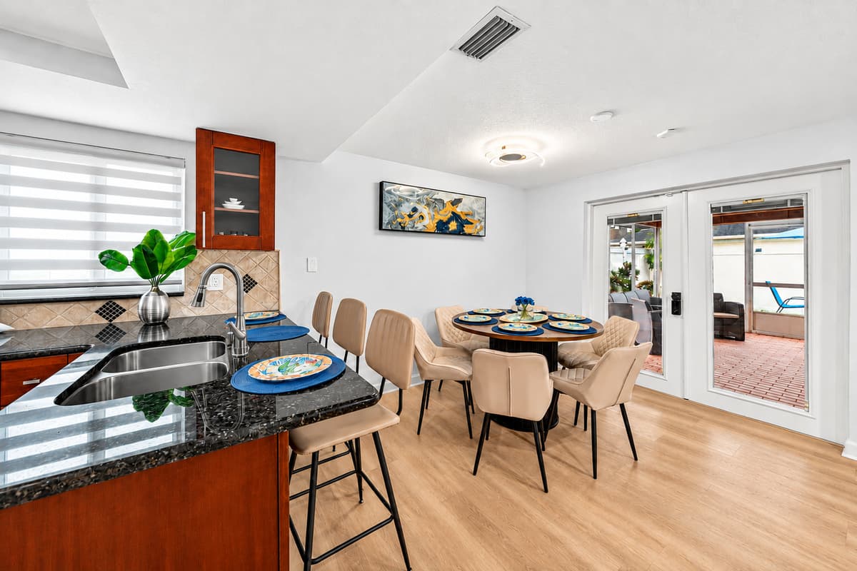 Kitchen breakfast bar and dining area offering convenient seating for casual meals, morning coffee, and family conversations.