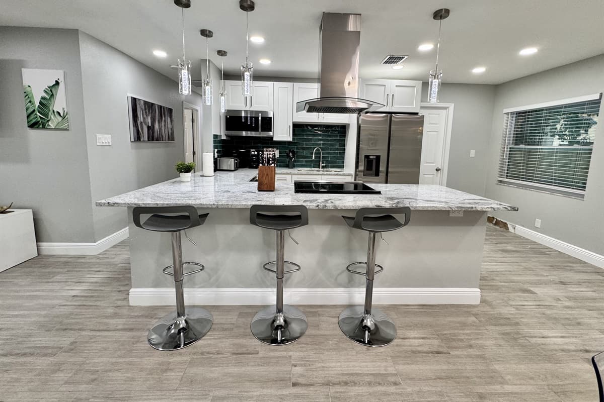 This modern culinary space features brand-new stainless-steel appliances, including a refrigerator, oven, microwave, and dishwasher, ensuring you have everything you need to prepare meals effortlessly.