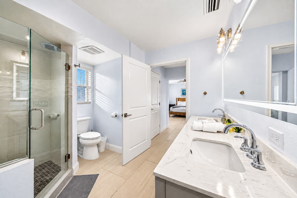 A walk-in shower big enough to actually unwind. Bright, modern and spotless, with a soaking tub alongside and towels stacked and ready. Rinse off the beach and start the night over fresh.