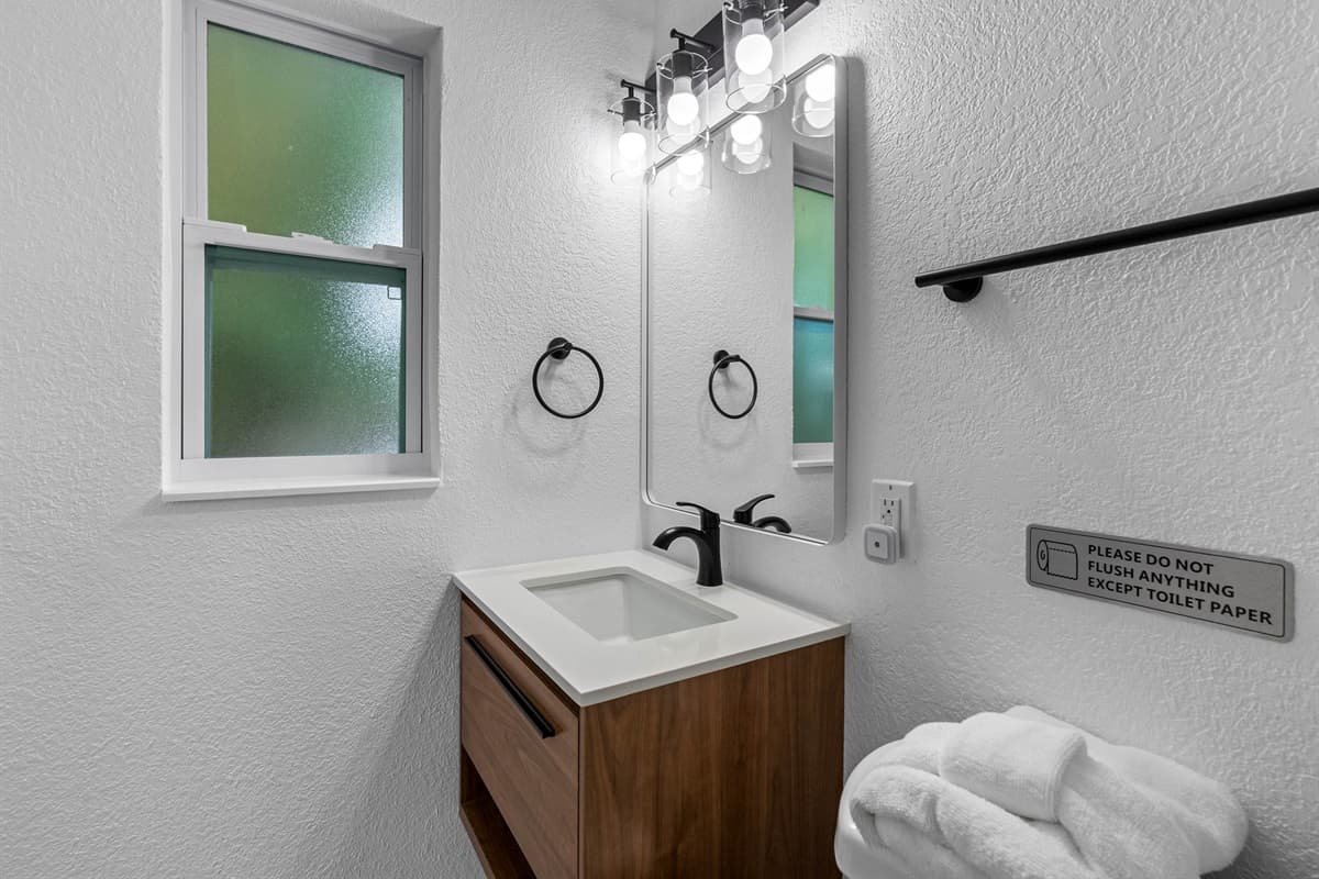 Clean lines and coastal luxury define this space—perfect for relaxing after a beach day or getting glammed up for a night out.