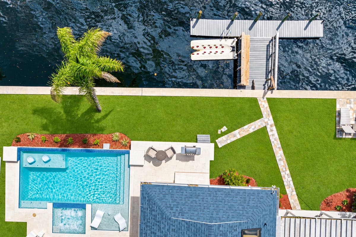 Top view of our immaculate property showcasing the stunning heated pool and lounge area at the back of the property. Love what you see? Ask us questions and send us an inquiry as soon as possible!