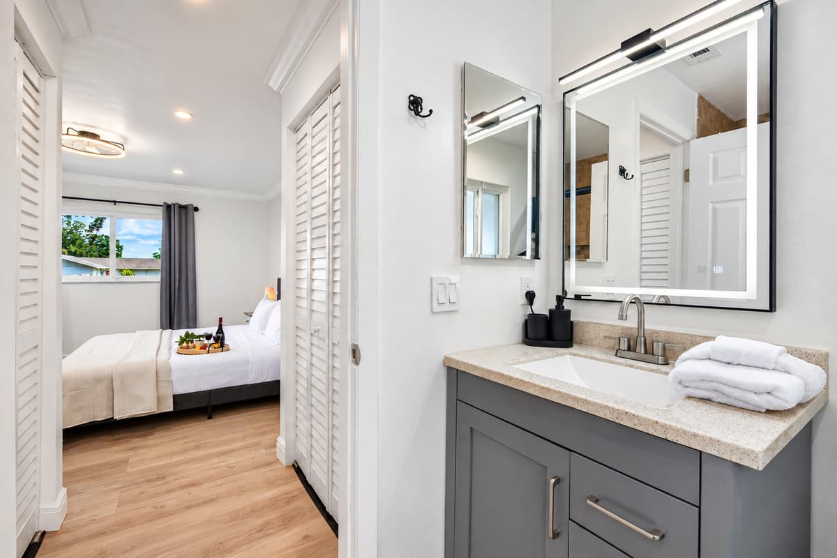 Wash the day away in a warm bath or quick shower—your retreat awaits behind sliding glass doors and warm tile accents.