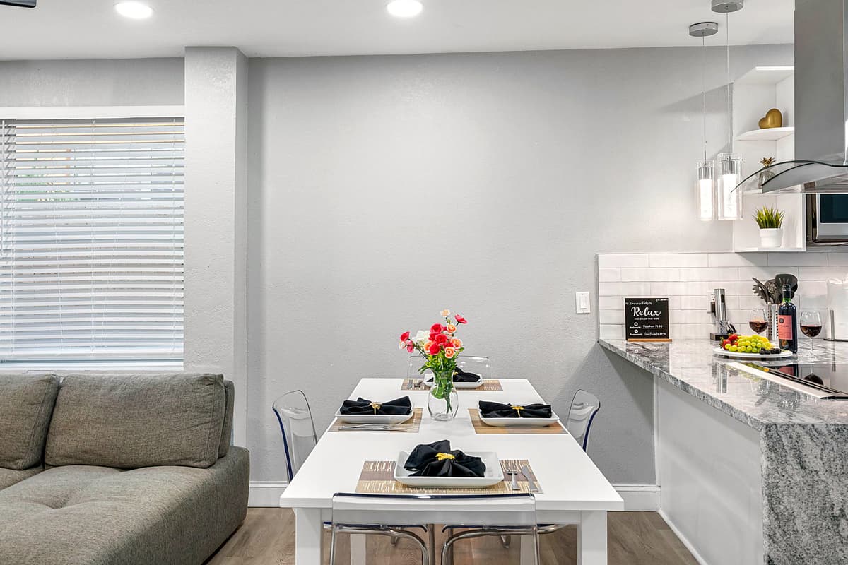 Positioned conveniently across from the kitchen, the dining area allows for easy serving and clean-up, making mealtime a seamless and enjoyable experience.