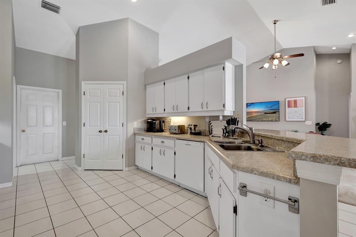 The spacious countertops, also in pristine white, offer plenty of room for food preparation, allowing you to unleash your culinary creativity.